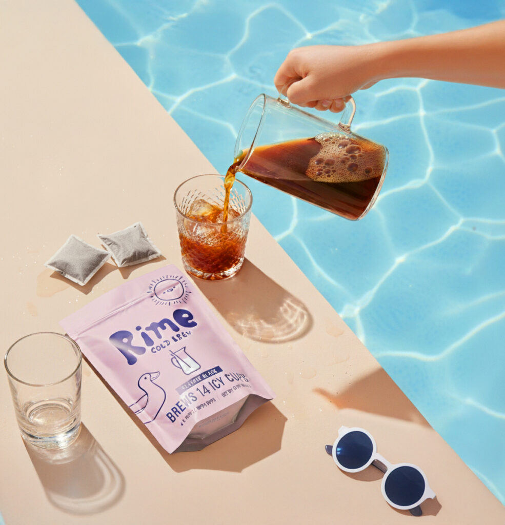 Rime cold brew poured into a glass by the pool