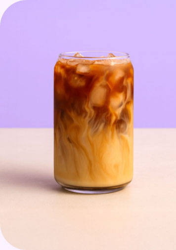 a glass of cold brew with milk in it
